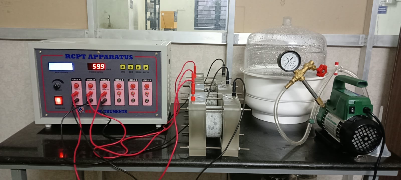 RCPT apparatus with concrete specimen cells at Falcon Industrial Testing Laboratory, Chennai.